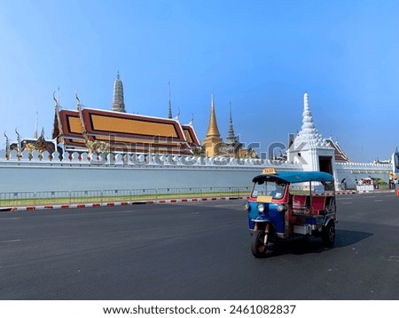 TUK TUK - famous traditional unique tribike taxi as a symbol of Thailand on a street infront of The Royal Grand Palce