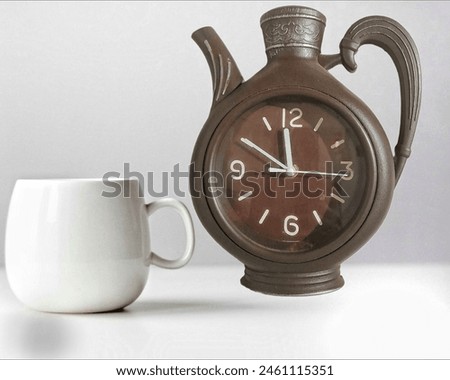 close up of a teapot character wall clock with a cup and white background 