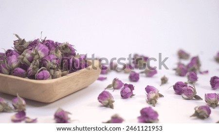 Dried damask roses in wooden plate. for natural herbal cosmetics