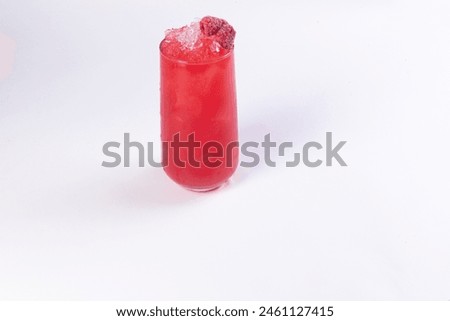 Red cocktail decorated with raspberries in a glass on a light background. Selective focus.