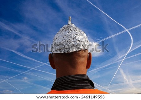 Conspiracy theorist icon image: Aluhut wearer looks at a sky full of chemtrails (composing)