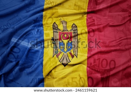 waving colorful national flag of moldova on a euro money banknotes background. finance concept. macro shot