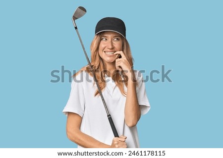 Young blonde golfer in studio relaxed thinking about something looking at a copy space.