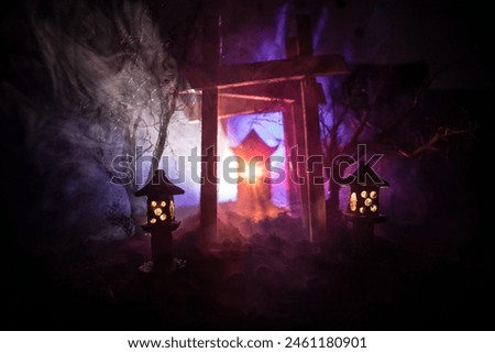 Creative artwork decoration. Abstract Japanese style wooden tunnel at night. Night scene in fantasy forest. Selective focus Royalty-Free Stock Photo #2461180901