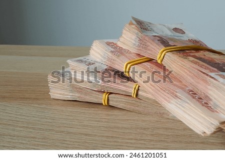 Stack of Russian rubles banknotes on wooden table, close up
