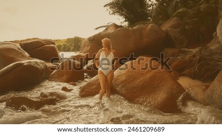 Portrait of a woman with long blond hair on a tropical beach