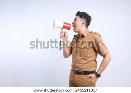 Male Civil Servant Wearing Uniform Announcing Information Using Megaphone on Gray Background