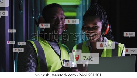Image of notification bars over african american standing with laptop in server room. Digital composite, multiple exposure, social media, teamwork, data center, networking, technology.