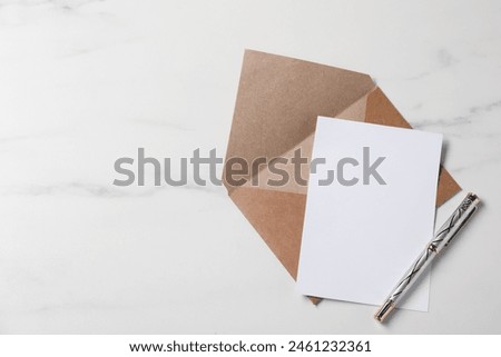 Blank sheet of paper, pen and letter envelope on white marble table, top view. Space for text