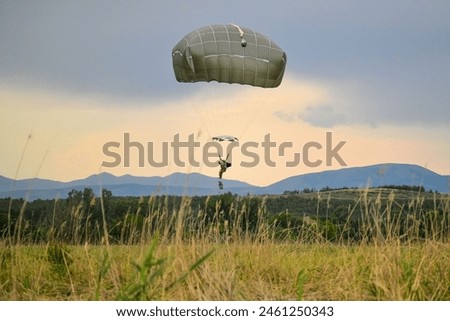 U.S. Army paratroopers, assigned to the 173rd Airborne Brigade, jump from a U.S. Air Force C-17 Globemaster III Royalty-Free Stock Photo #2461250343