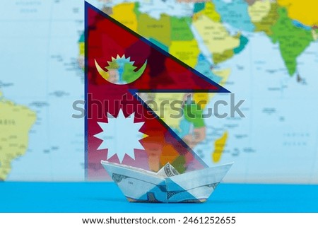Sea transport of Nepal concept, paper ship with Nepal flag, cargo and logistics idea, bulk carrier