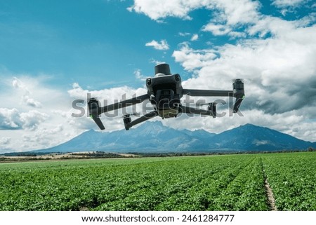 Aerial view of a drone moderning over farm fields, monitoring, analyzing crop health. Agricultural drone in modern farming.