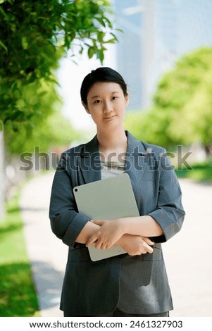 Confident Businesswoman Working Outdoors with Tablet
