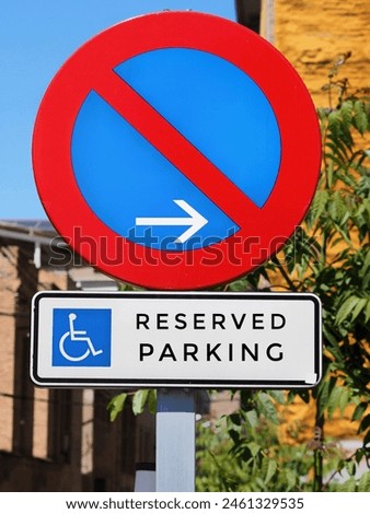 A red and blue no parking sign is next to a sign that says "reserved parking" with a wheelchair symbol