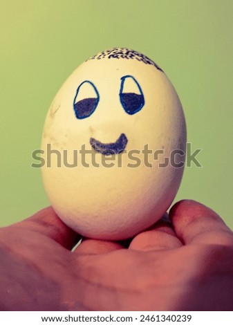chicken egg with smile on fingers