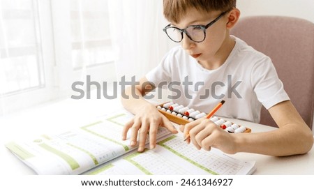 Boy doing mental arithmetic on abacus at school