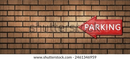 Red wooden shooter sign with the inscription PARKING hangs on a dark brick wall. Left arrow pointer. Direction indicator