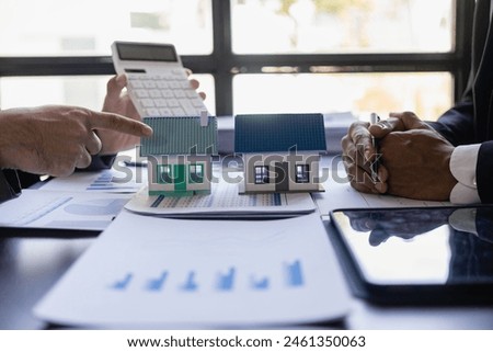 Real estate agent, house model, close up of house, keys and small toy house on table, lawyer, legal advisor, real estate agent, bank manager, signing mortgage agreement