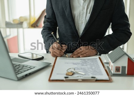 Real estate agent, house model, close up of house, keys and small toy house on table, lawyer, legal advisor, real estate agent, bank manager, signing mortgage agreement
