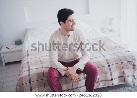 Photo of cheerful nice man waking up weekend morning in comfortable white day light room interior indoors Royalty-Free Stock Photo #2461362923