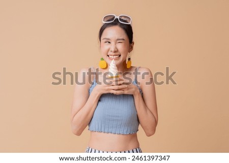 summer freshness asian cheerful swimwear woman wear sun glasses hand hold ice cream sweet dessert smiling happiness summertime advertisment studio photoshoot cute and curious friendly on color screen