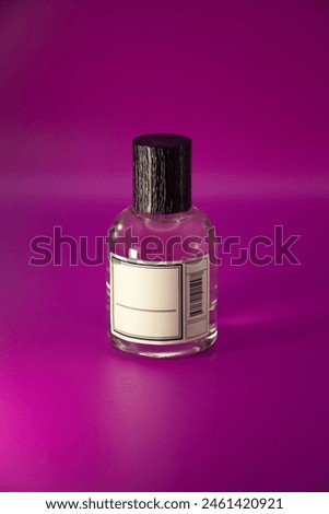 Perfume bottle mock up with the black textured cap and empty 
label  isolated on pink background Royalty-Free Stock Photo #2461420921