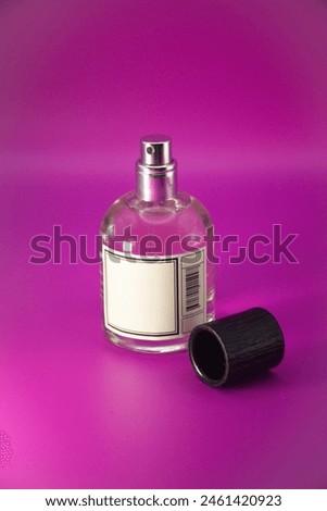 Perfume bottle mock up with the black textured cap and empty 
label  isolated on pink background Royalty-Free Stock Photo #2461420923