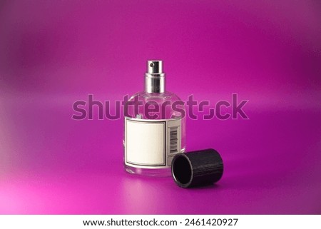 Perfume bottle mock up with the black textured cap and empty 
label  isolated on pink background Royalty-Free Stock Photo #2461420927