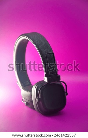 retro black headphone isolated on pink background Royalty-Free Stock Photo #2461422357
