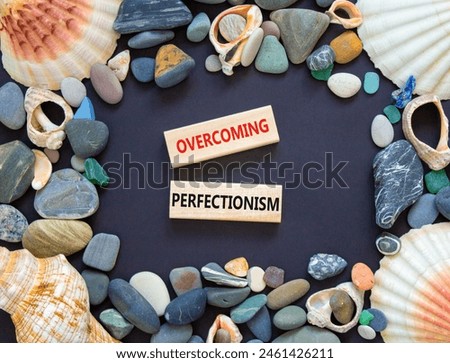 Overcoming perfectionism symbol. Concept words Overcoming perfectionism on beautiful wooden block. Sea shell. Beautiful black paper background. Business Overcoming perfectionism concept. Copy space.