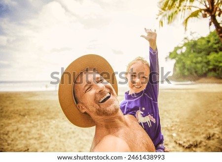 A nice man having great time on beach with his daughter