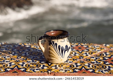 traditional mexican cup of coffee, facing the sea Royalty-Free Stock Photo #2461453019