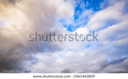 Ornamental clouds. Dramatic sky. Epic storm cloudscape. Soft sunlight. Panoramic image, texture, background, graphic resources, design, copy space. Meteorology