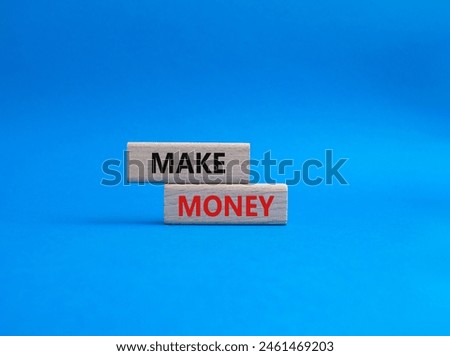 Make Money symbol. Wooden blocks with words Make Money. Beautiful blue background. Business and Make Money concept. Copy space.