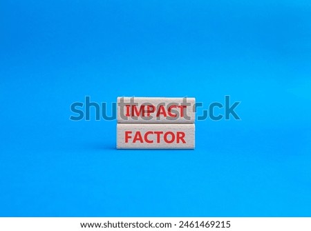 Impact Factor symbol. Wooden blocks with words Impact Factor. Beautiful blue background. Business and Impact Factor concept. Copy space.