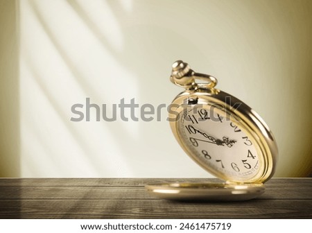 vintage golden pocket watch on the desk