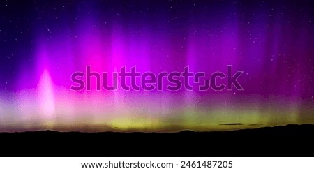 This is a shooting star barreling through the Aurora Borealis in Idaho  Royalty-Free Stock Photo #2461487205