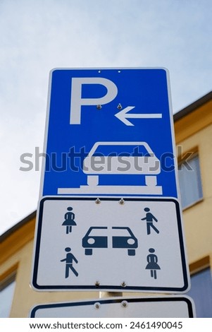 Car sharing parking sign with blurred background. The sky is visilble.