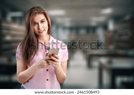 Girl student hold mobile phone in university Royalty-Free Stock Photo #2461508493