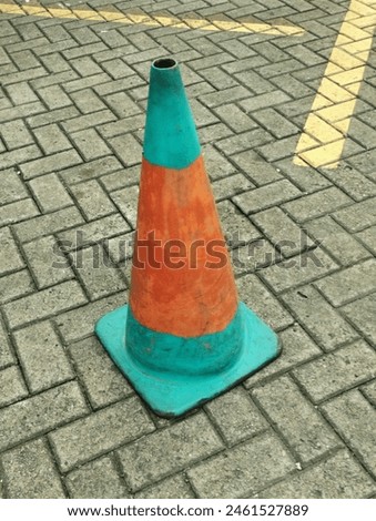 a dirty traffic safety cone in unique color