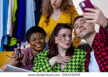 Concept of diversity, friendship between men and women, spending time together, having fun, laughing, smiling. Young people, generation z, millennial taking photo at swap party, secondhand store