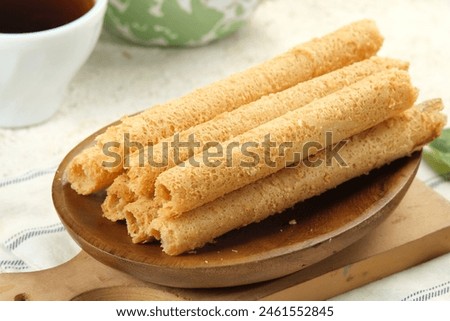Egg Roll Biscuit or Kue Semprong or sapit, Simping, kue Belanda, or kapit or Love letters in English. It is an Indonesian traditional wafer snack or kuih. Royalty-Free Stock Photo #2461552845