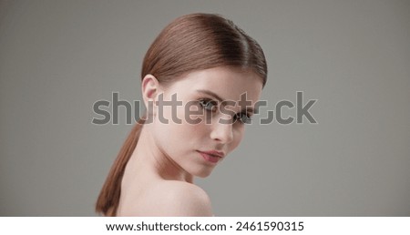 Beauty, health, cosmetics, anti-aging therapy and skin care concept - young beautiful brunette Caucasian woman posing and looking at the camera with a calm confident look