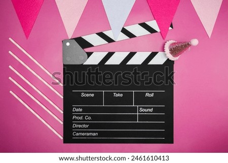 Cinema clapper board and birthday decorations, festive atmosphere, party hats and colorful streamers