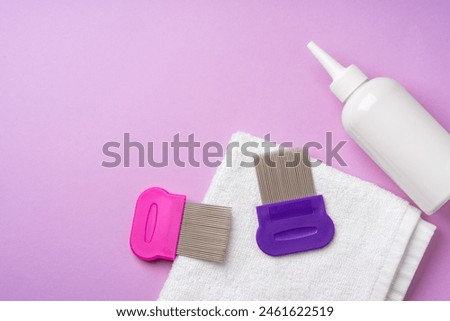 Anti lice combs and towel on pink background