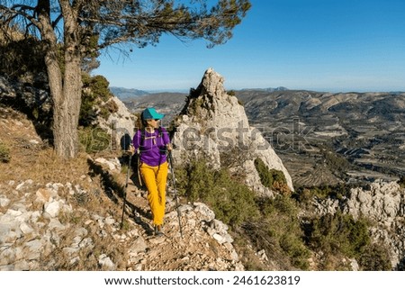 A woman hiking in the mountains, Serrella peak Quatretondeta, Alicante, Spain - stock photo