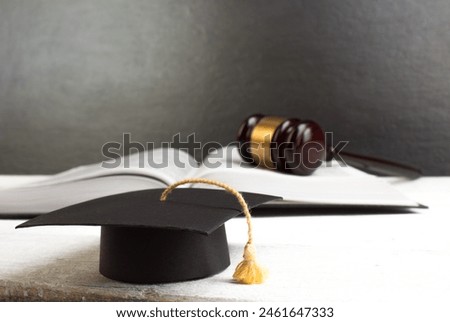 Law concept, education concept - Open law book with a wooden judges gavel on table in a courtroom or law enforcement office. Copy space for text