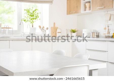 Empty dining table with chairs in modern kitchen furniture interior of pastel color