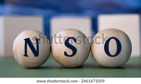 NSO (Non-Qualified Stock Option) - acronym on wooden balls on the background of wooden large cubes