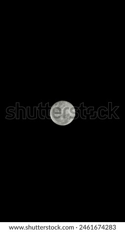 Breathtaking full moon shining brightly in the dark night sky. Highlights the moon's detailed surface. Ideal for calendars, posters, backgrounds, and marketing materials.